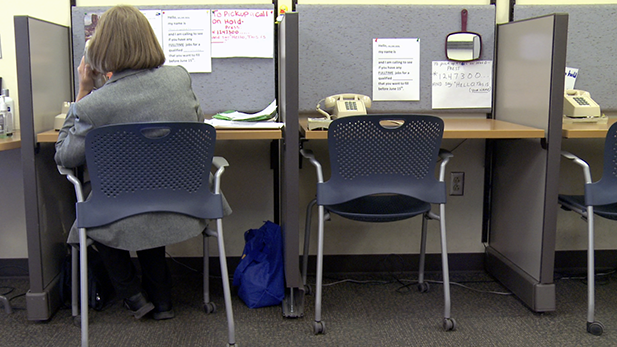 A woman calls potential employers from a phone bank at Pima County's Sullivan Jackson Employment Center