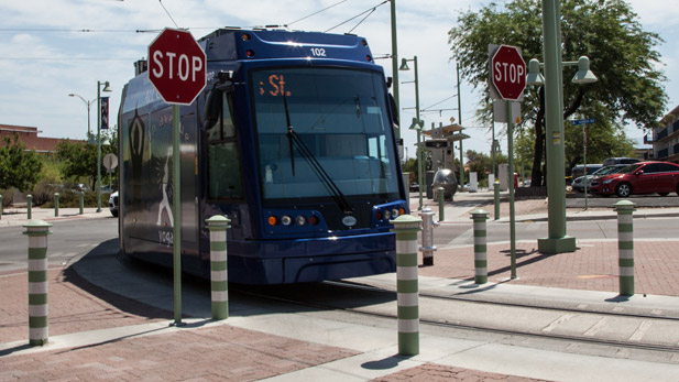 The modern streetcar navigates through an intersection.