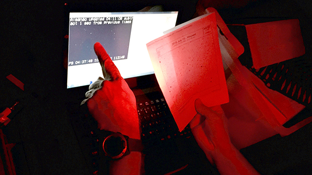 Ken Conway matches a star field map to the view seen through his telescope and recorded on a laptop.