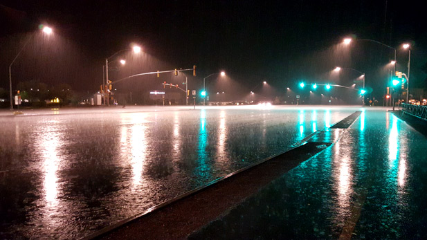 Heavy rainfall from a monsoon storm floods an intersection in east Tucson.