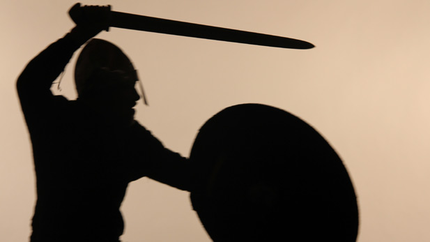 Silhouette of a Viking warrior with shield. 