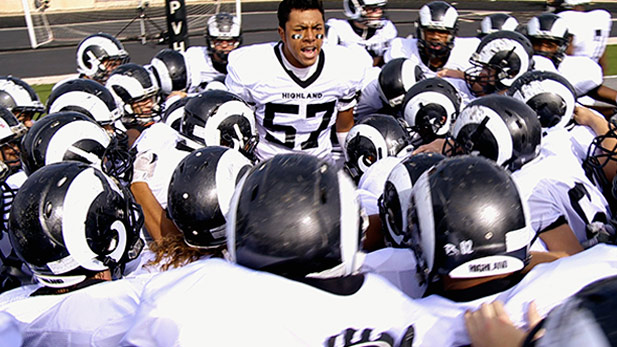 Fihi leads teammates in a football chant before championship game.