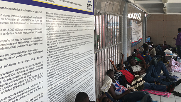 A group of Haitian immigrants wait in Mexico's Nogales port of entry for an interview with a U.S. Customs and Border Protection official.