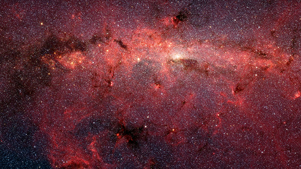 This dazzling infrared image from NASA's Spitzer Space Telescope shows hundreds of thousands of stars crowded into the swirling core of our spiral Milky Way galaxy. In visible-light pictures, this region cannot be seen at all because dust lying between Earth and the galactic center blocks our view.