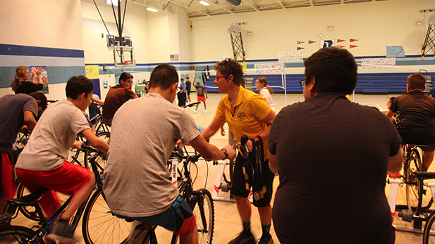 An Indoor El Tour bike ambassador encourages students at Billy Lane Lauffer Middle School.