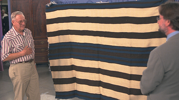 Donald Ellis (right) appraises a Navajo Ute First Phase blanket, ca. 1850 in Tucson, Arizona.