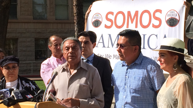 Roberto Reveles, at microphone, and other Somos America members announce the possibility of a renewed boycott over immigration legislation.