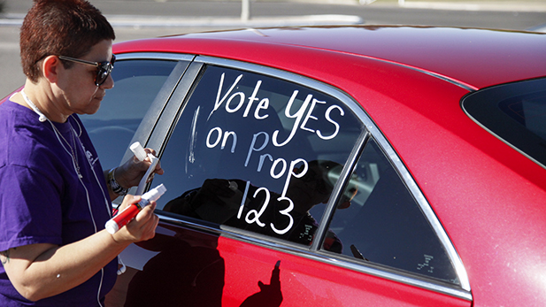 Sunnyside Education Association President Mary Martinez paints her car in support of Proposition 123 on April 4, 2016. 