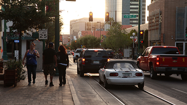 People walk along the streetcar route in downtown Tucson on April 5, 2016. 