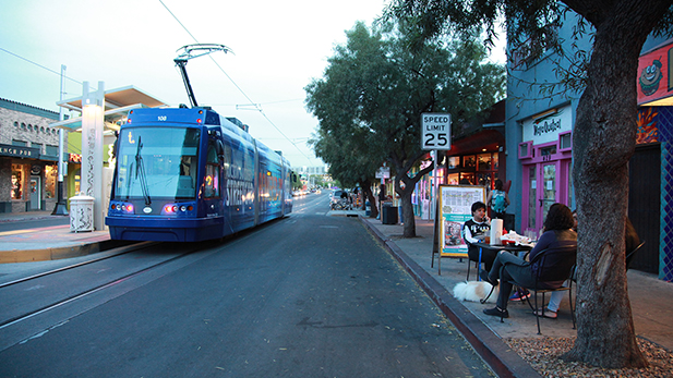 The streetcar passes people eating dinner on 4th Avenue on April 5, 2015. 