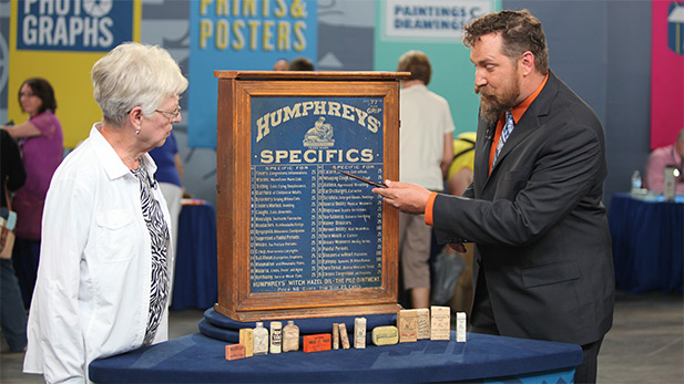 James Supp (right) appraises a Humphreys' homeopathic medicine cabinet in Omaha, Nebraska.
