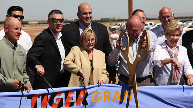 Preparing to cut the ribbon on the Port of Tucson's new 'off-ramp' are (left to right): Port VP Matt Levin, Union Pacific's Paul McDonald and Wes Lujan (back), Pima County Supervisor Sharon Bronson, Port President Alan Levin and his wife Jan.