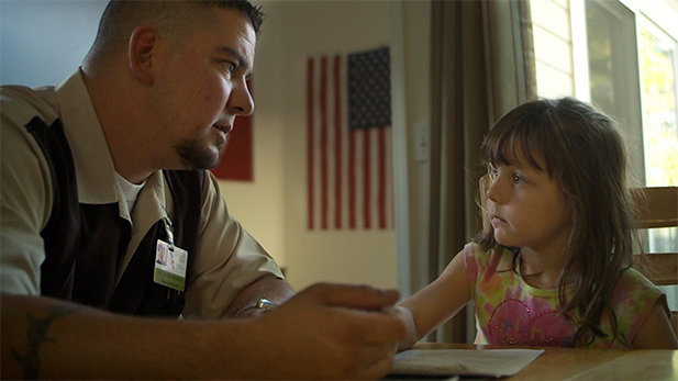 A veteran and his daughter at home.