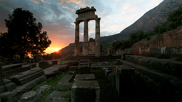 Sun sets behind the Temple of Athena at Delphi.