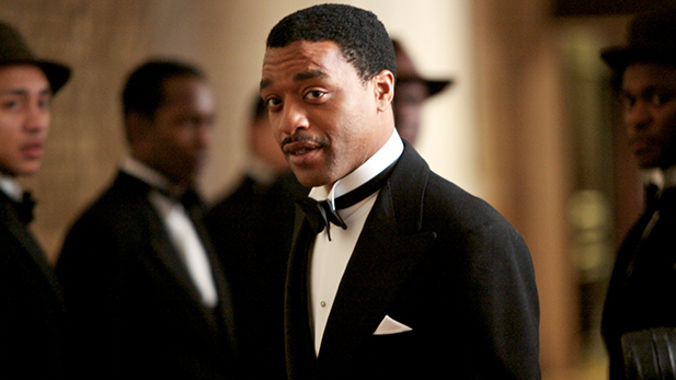 Chiwetel Ejiofor as 'Louis'(centre), with ‘Band Members’, Miles Brett as ‘Band member 6 Tenor Sax’.