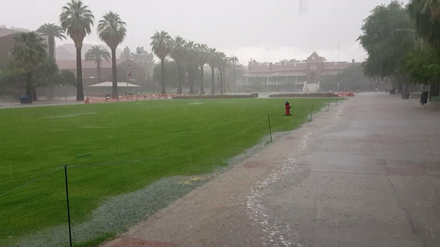 An intense rainstorm floods the mall on campus of the University of Arizona.