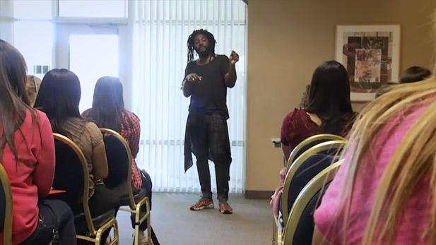 A man lectures to teens at the Creative Arts Teen Summit.