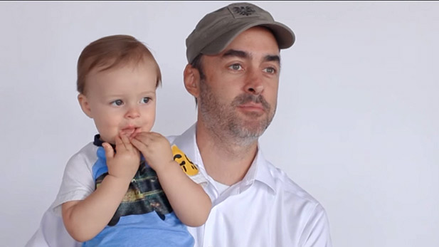 A father and his son speak to a a camera.
