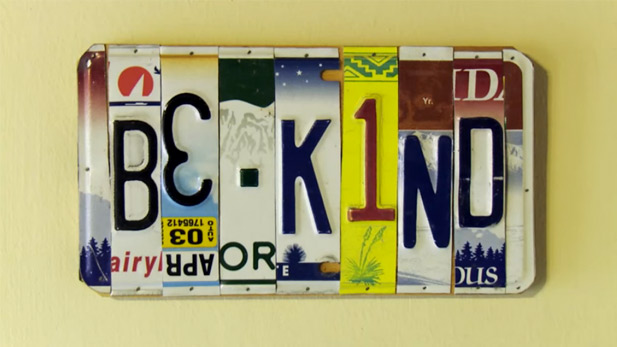 A license plate spells out, "Be Kind."