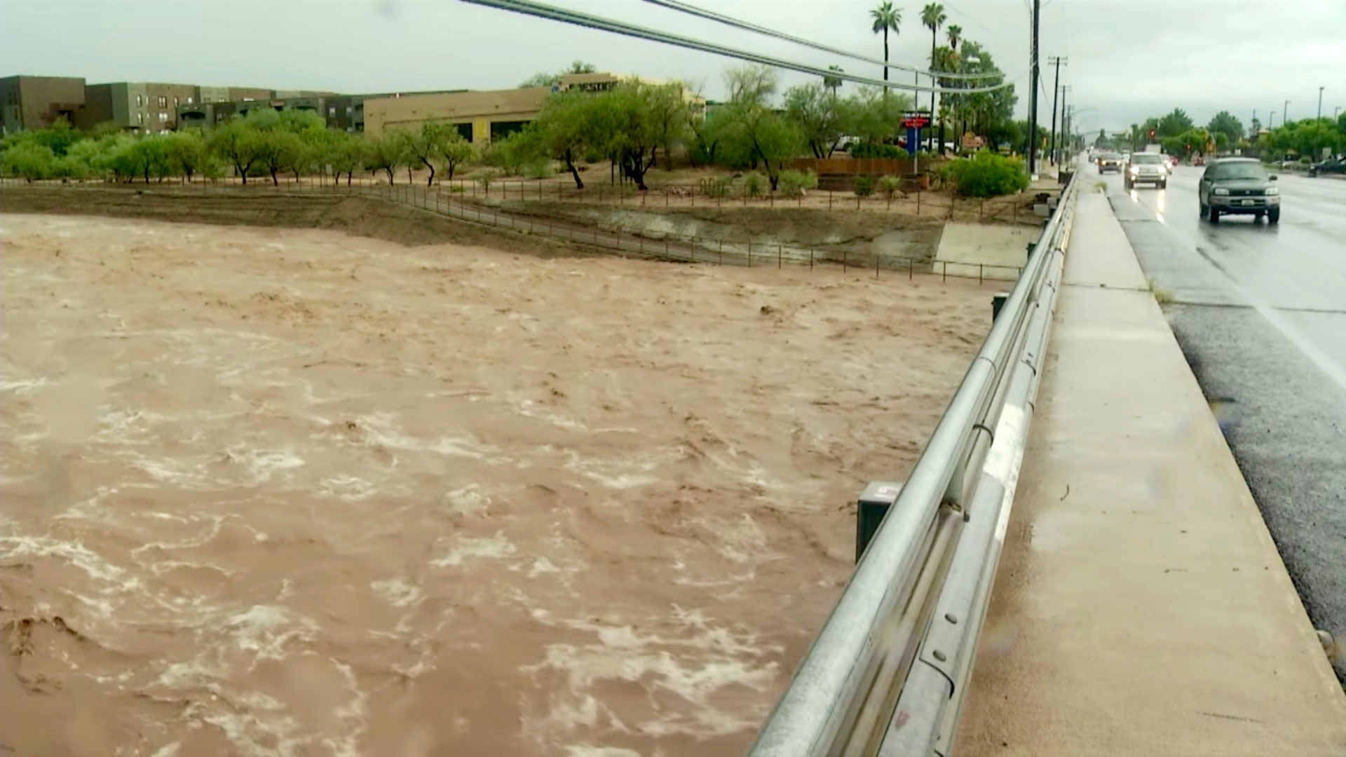 A wash in Tucson begins to flood its banks after heavy monsoon rain.