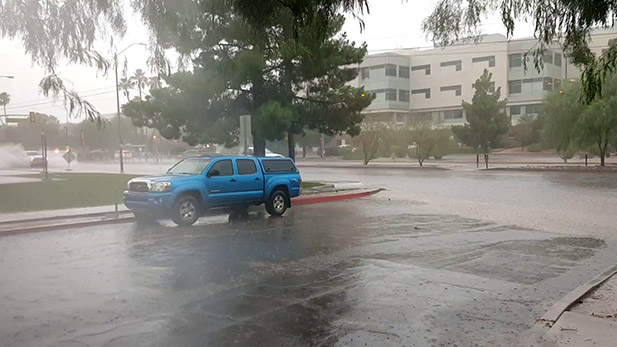 Heavy rain floods Campbell north of Speedway.