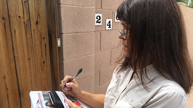 Victoria Steele, a candidate in the Democratic primary Arizona's 2nd Congressional District, leaves campaign literature while going door-to-door.  Summer 2016.