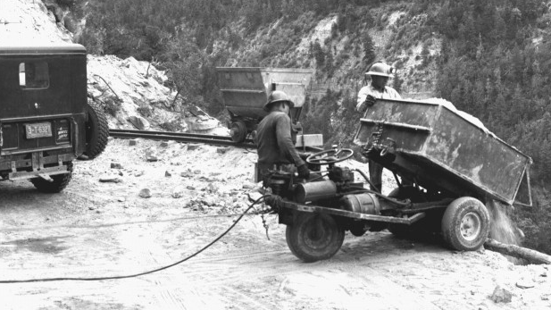 Navajo uranium miners dump tailings over the side of a mesa in a photo dated 1952.