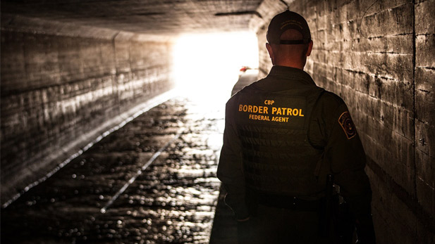 Border Patrol agents inspects a water drainage tunnel that spans from Nogales, AZ into Mexico. 