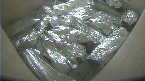 Migrants awaiting processing inside CBP facilities wrap themselves in mylar blankets provided by the agency to keep warm.
