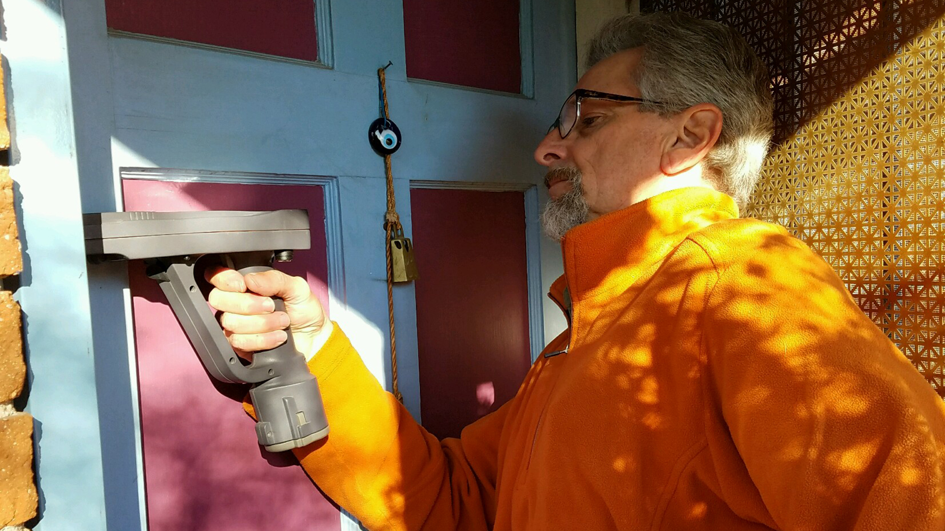 Chuck Phelan uses an XRF gun to test a home's door jamb for traces of lead. Homes are considered positive for lead if they test at a level of one milligram of lead per square centimeter.