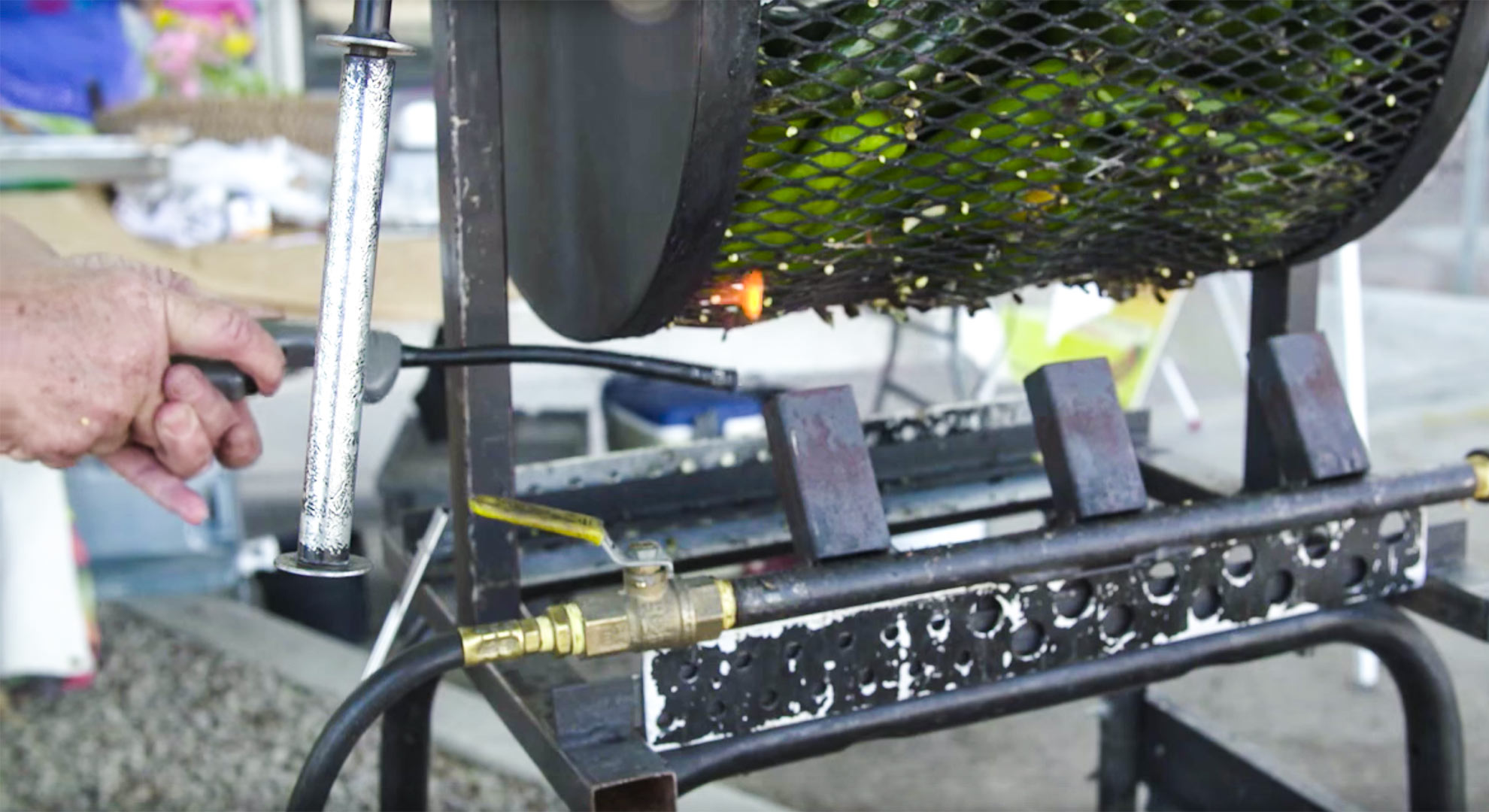 Lighting the flame to roast green chiles at a farmers market in Tucson.