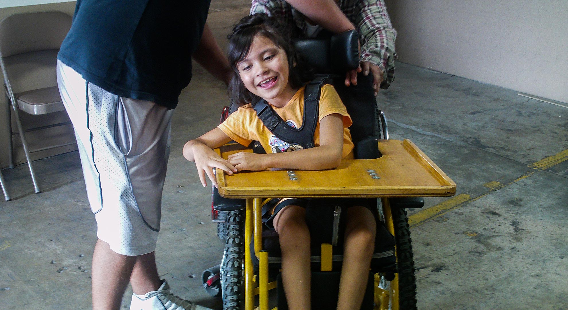 A child gets her first wheelchair built by ARSOBO, a nonprofit in Nogales, Sonora.