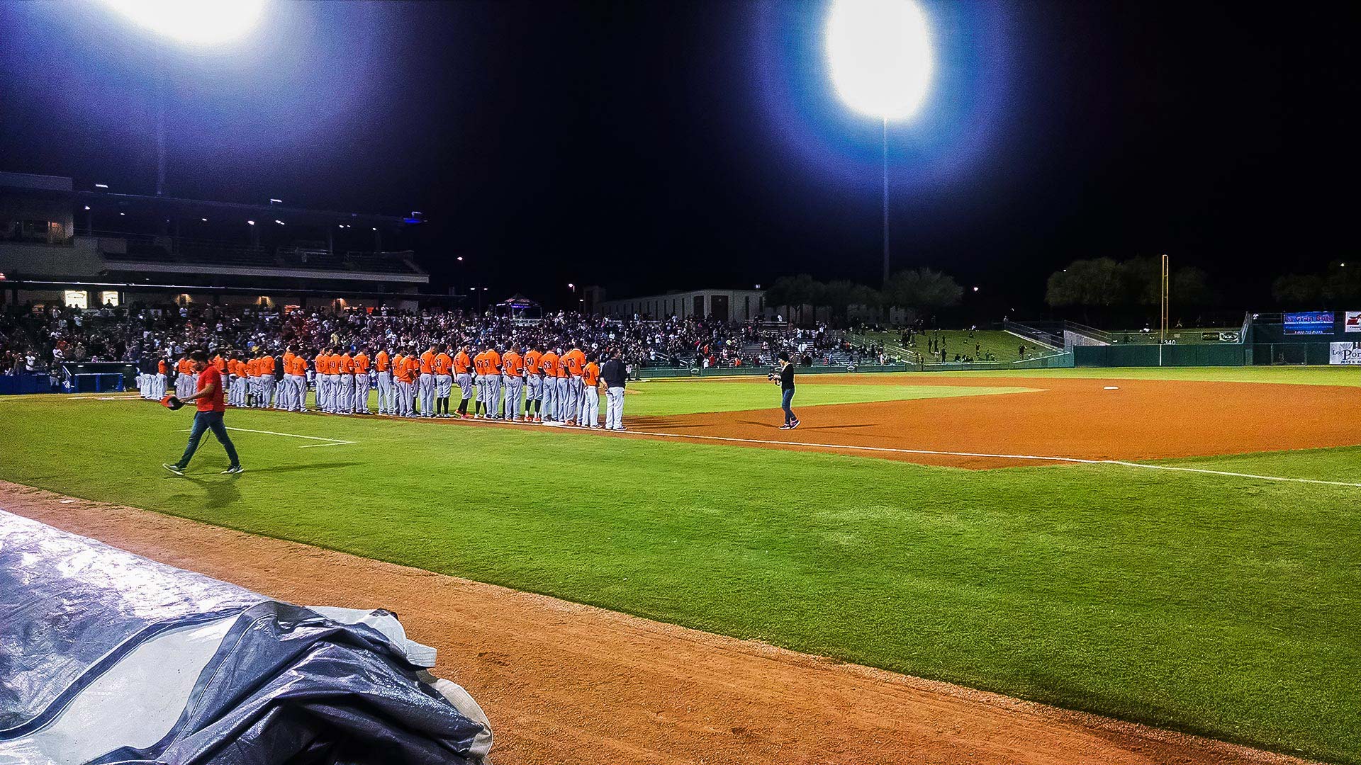 The Naranjeros of Hermosillo, Mexico, line up for the national anthems of Mexico and the U.S. during the Mexican Baseball Fiesta in Tucson, Sept. 29, 2016.