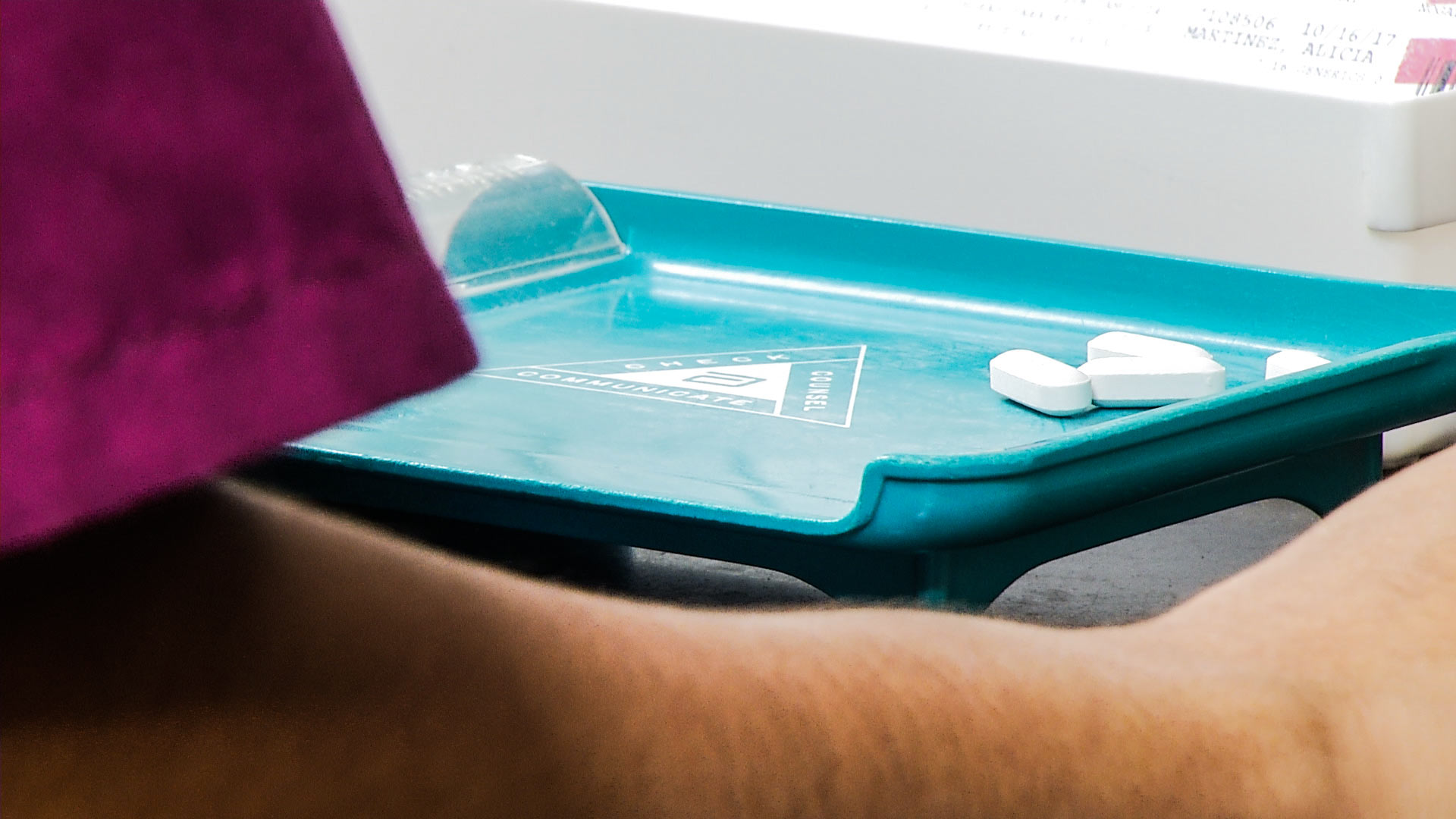 A health worker portions out pills.