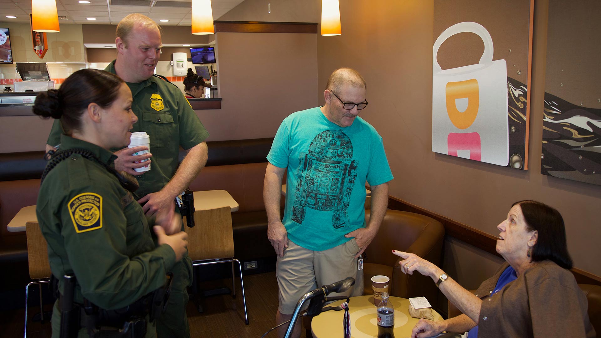 [from left] Agents Stephanie Dixon and Jacob Stukenberg chat with Mike Katzorke and Nancy Swartzmiller. Among the questions the couple had for the agents was what gear do they carry on their belts and why they wear long sleeves in the summer.