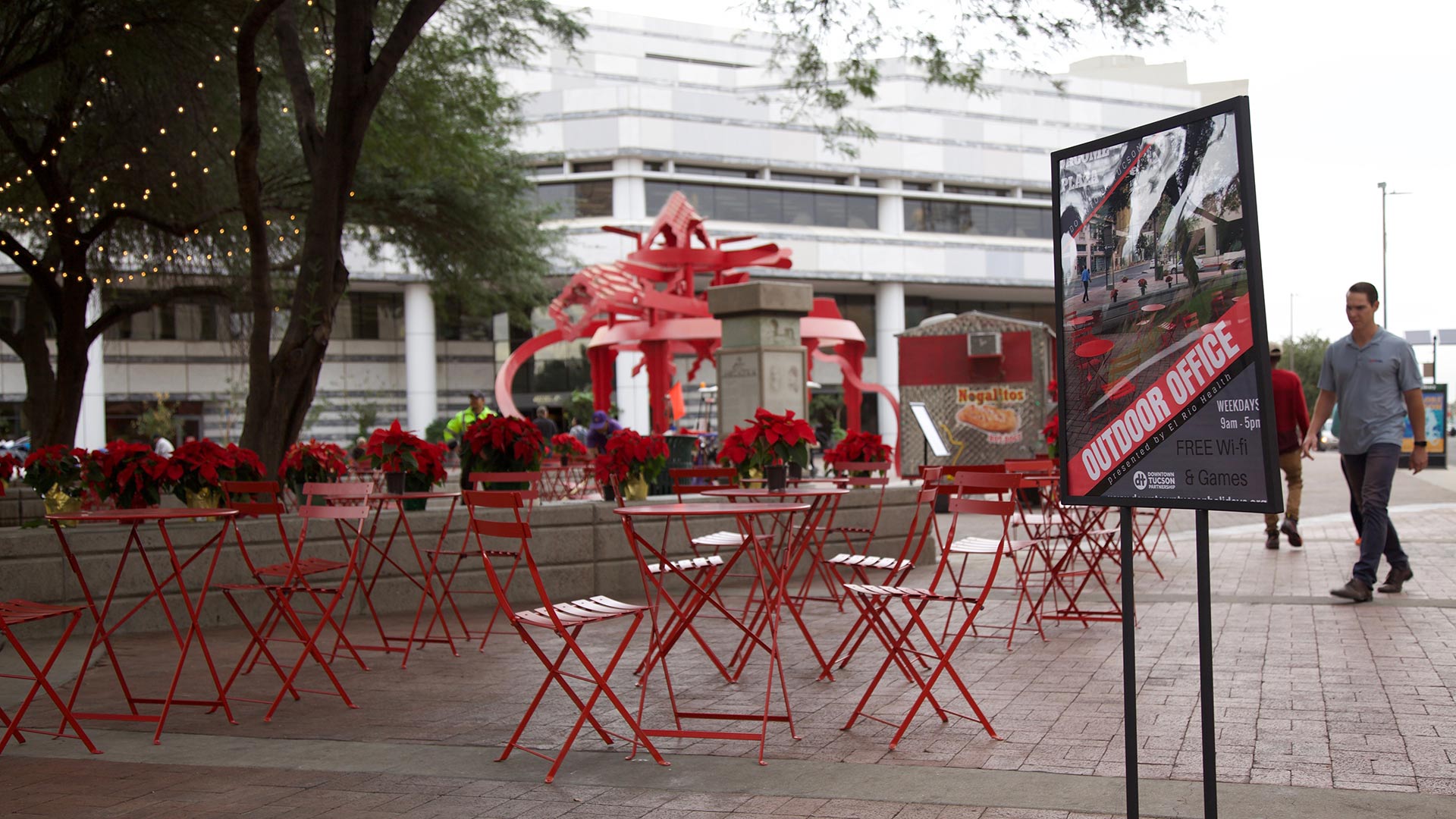 Red tables and lawn games now take up portions of the space under the trees at Jacome Plaza in downtown. The Outdoor Office is open to the public Monday through Friday from 9:00 a.m. to 5:00 p.m.