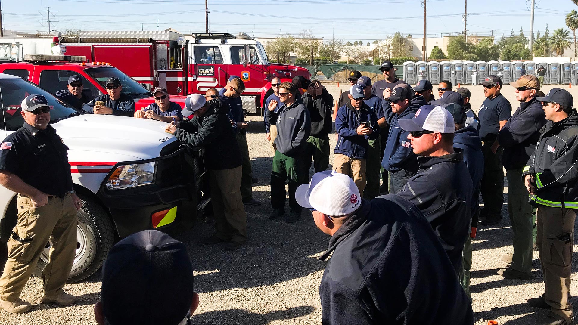 Department of Forestry and Fire Management Central District Manager Dan Colgan, far left, briefs Arizona crews set to fight fires in California, Dec. 6, 2017.