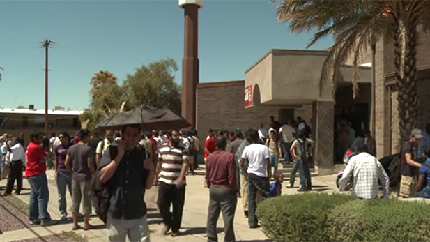 People mill about on a Friday outside of the Islamic Center of Tucson, 2011.