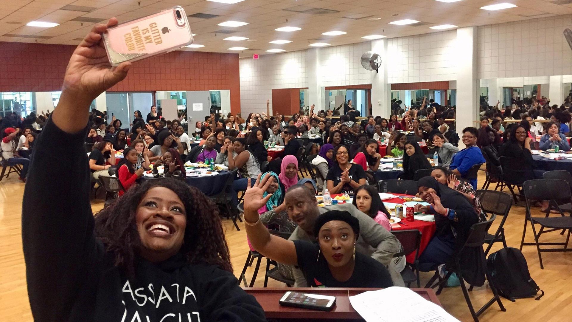 UA's KC Williams and Isoken Adodo and TUSD's Jimmy Hart take a selfie with 100 middle school girls during a visit to the UA campus. 