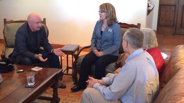 Mark Kelly (left) and Gabrielle Giffords visit in their home with David and Penny Welch, to whom Kelly and Giffords presented Welch's father's World War II Navy uniform, Feb. 13, 2015.