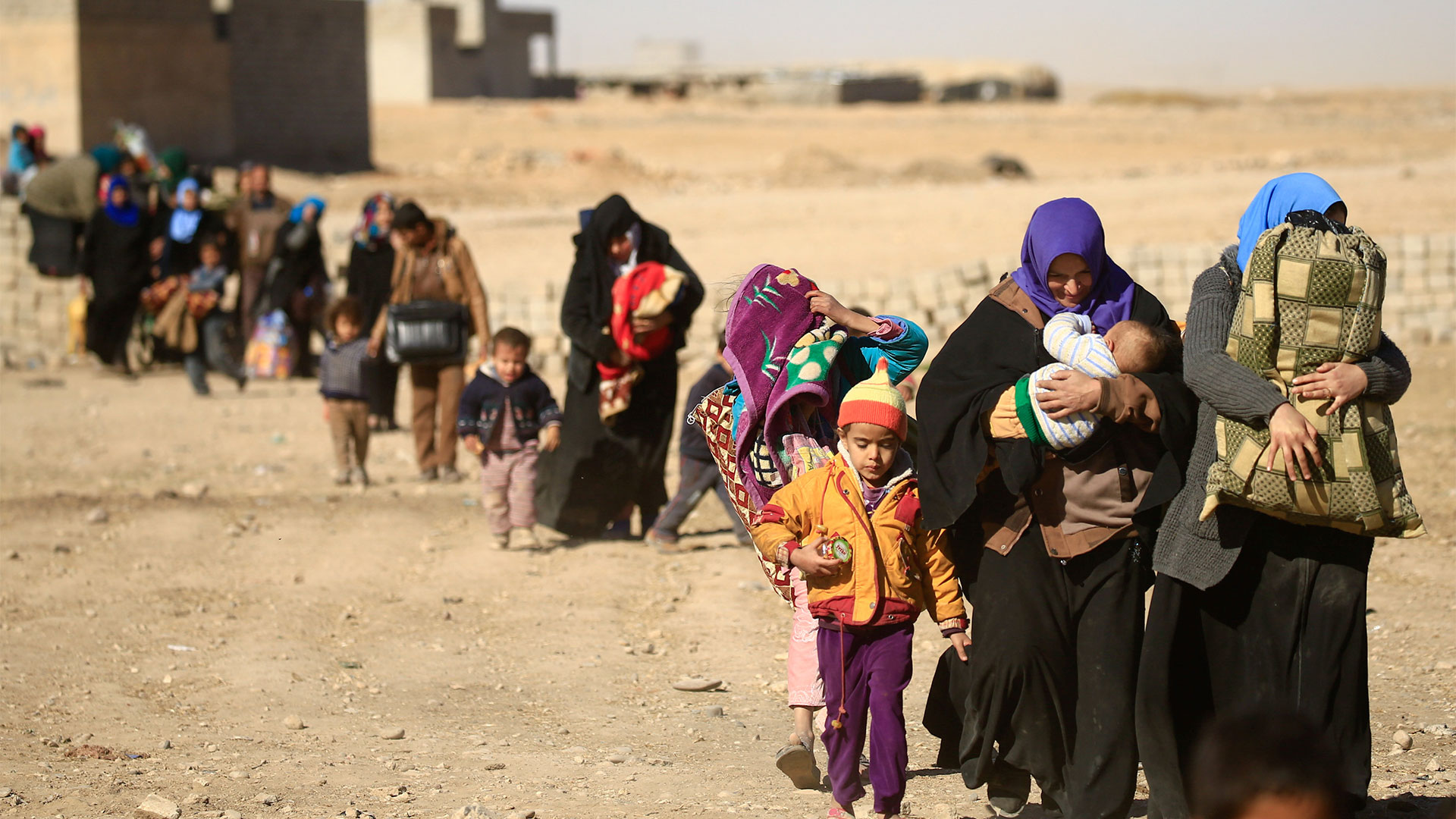 Displaced people walking in Mosul, Iraq, after fleeing from ISIS militants.