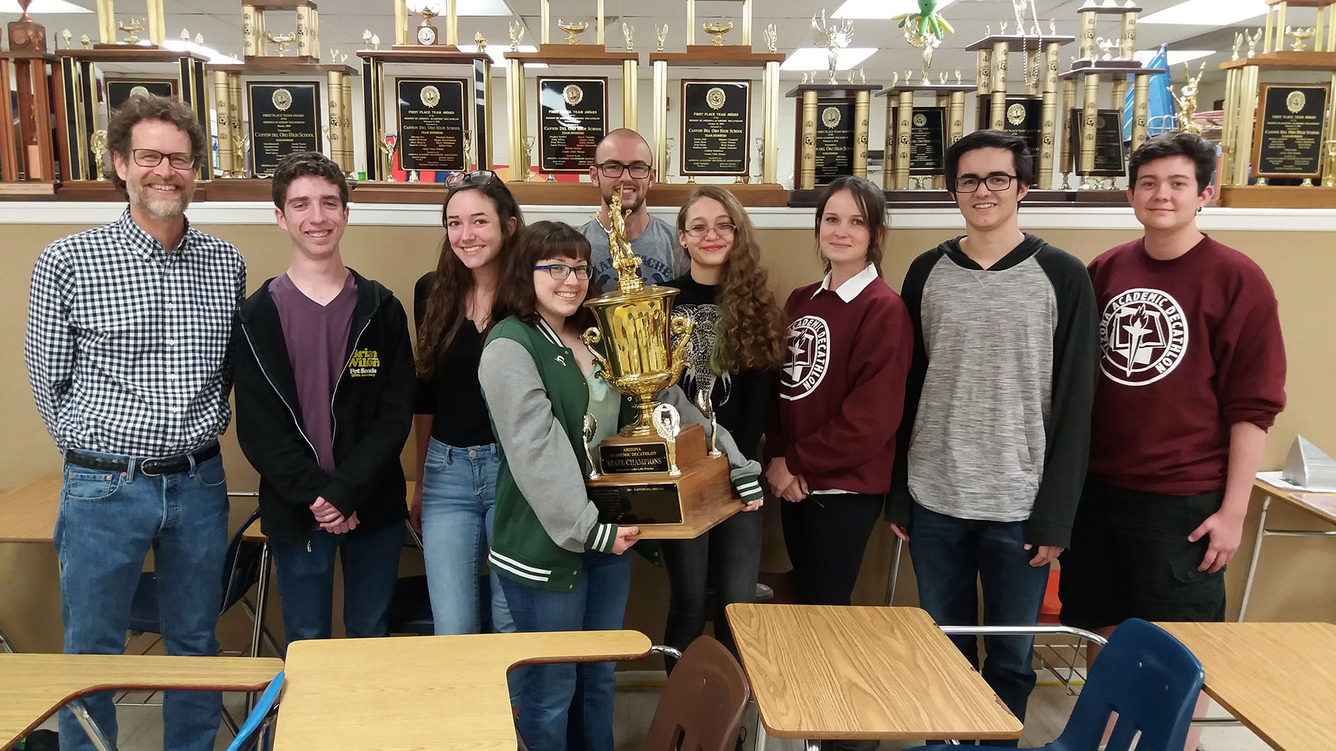 Canyon Del Oro High School's academic decathlon team, from left: Chris Yetman (coach), Brady Lybarger (senior), Chloe Penna (sophomore), Paige Dingman (senior), Albert Windes (junior), Allienna Nezelek (sophomore), Piper Gray (junior), Patrick Carswell (senior), Evan Cuillier (senior).