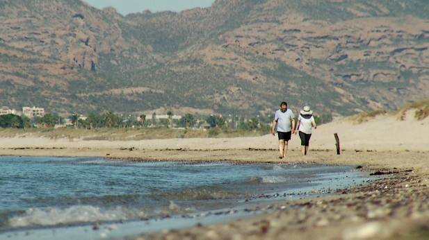 Couple on beach at San Carlos, Mexico, spotlight