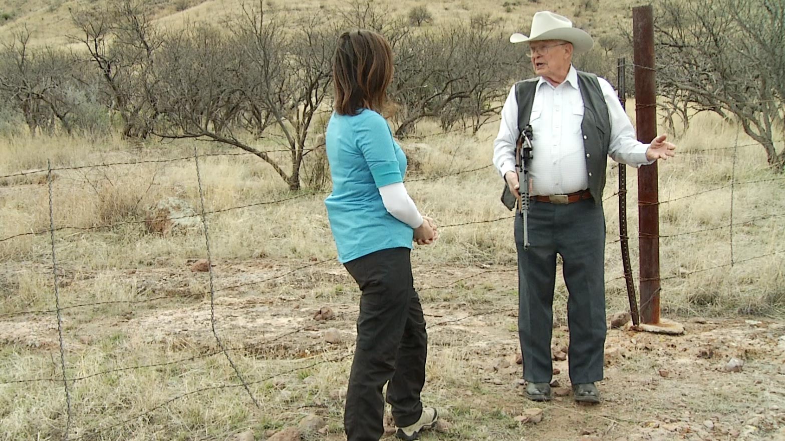 Arivaca rancher Jim Chilton speaks with AZPM's Lorraine Rivera at the international border fence on his ranch.