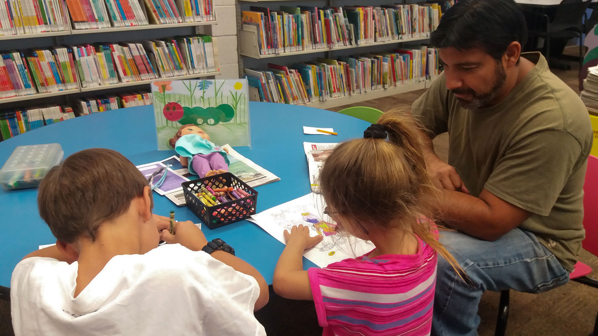 Man and kids in library unsized