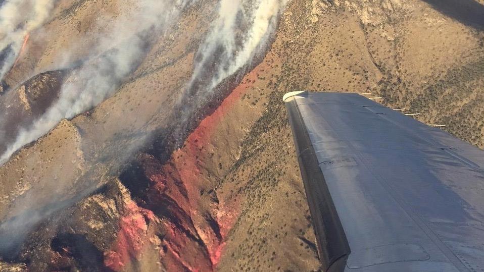 Sawmill Fire burning up ridge lines near Sonoita. Red tinge is residue of fire retardant dropped from air tankers.