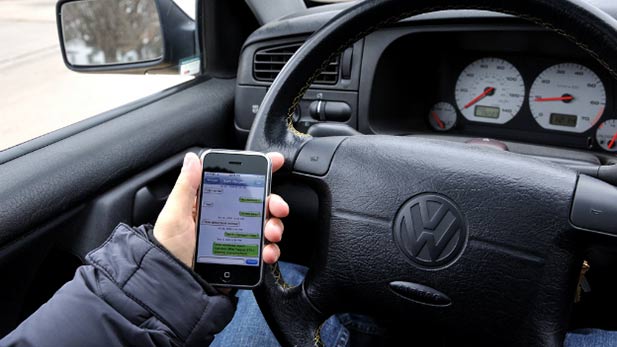 Using a cell phone while driving is now illegal in Tucson.