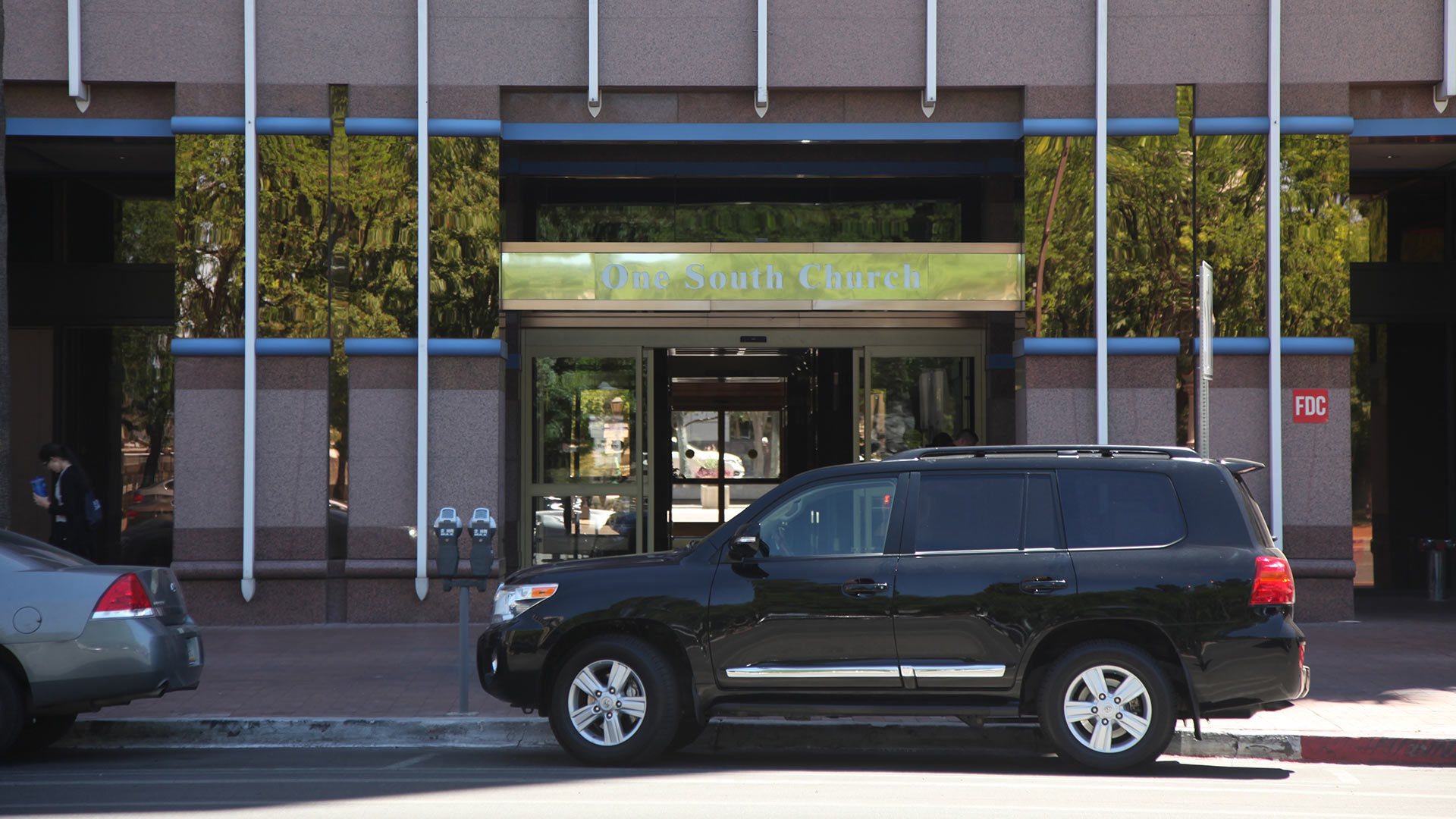 White lettering on a gold overhang on the westside entrance for One South Church.