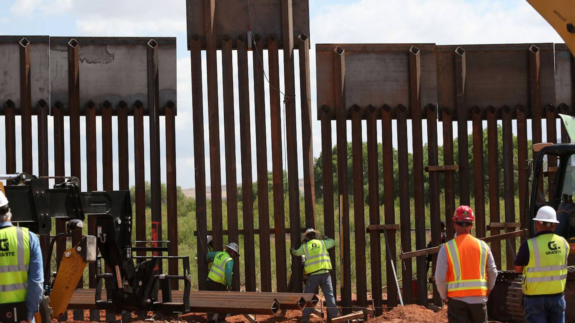 Workers install the final panel in an upgrade of 7.5 miles of border fence near Naco, May 9, 2017.