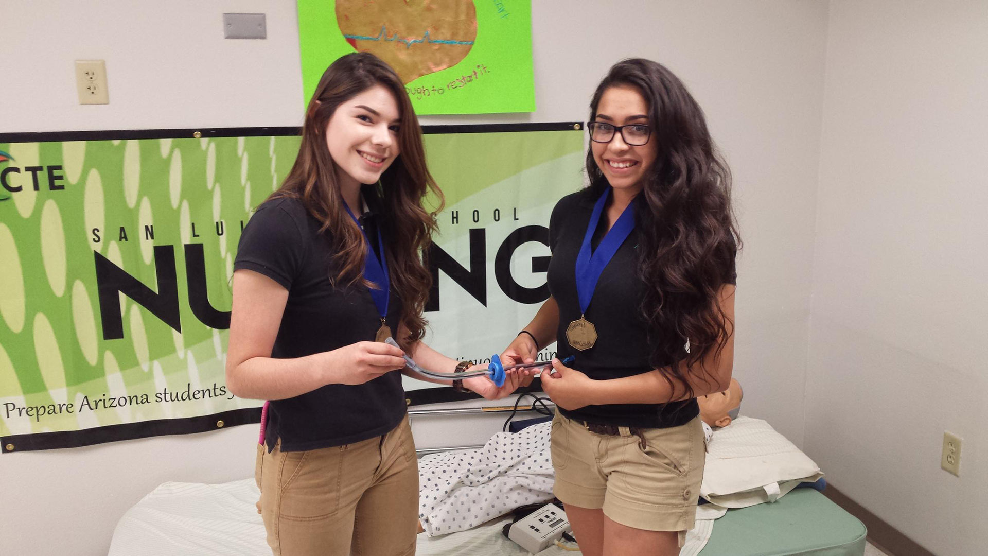 Kathy Angulo, left, and Alma Vizcarra hold their improved gastrostomy tube prototype